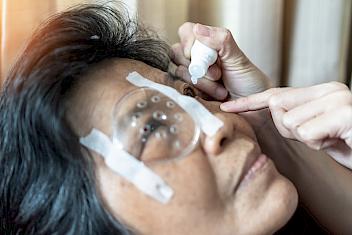 Woman being treated with drops for her macular degeneration